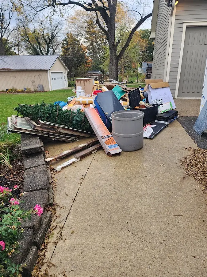 Dumpster being loaded with debris for Demolition Dumpster Rental in Devils Lake